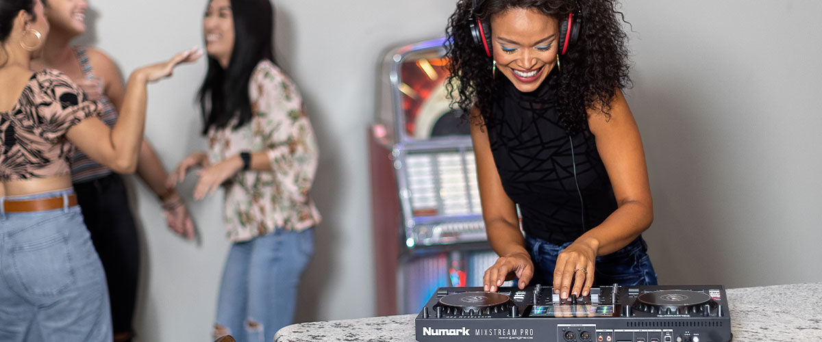 woman DJing for friends at house party
